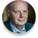 Portrait of an older man with a light blue shirt and green jacket