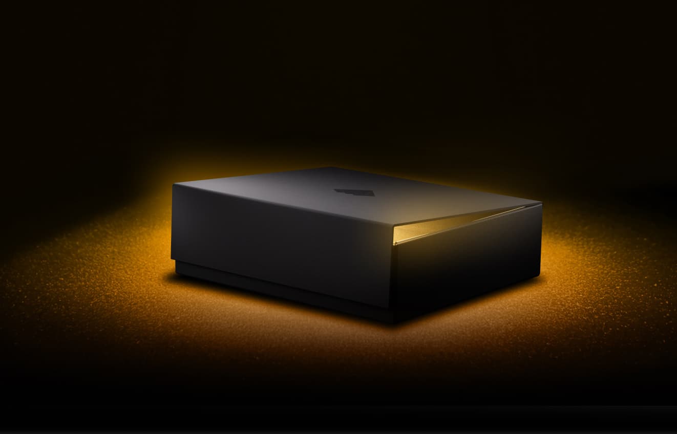 Closed black NGRAVE box glowing with golden light in the dark