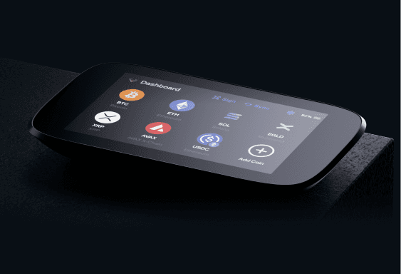 Close-up of NGRAVE ZERO on a dark ledge showing the coin dashboard on its touchscreen