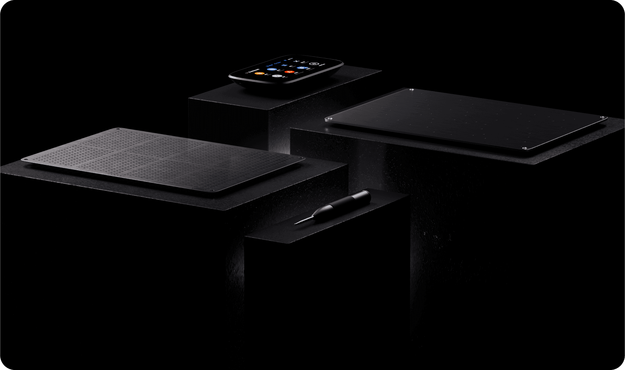 NGRAVE ZERO, two GRAPHENE steel plates and a punch tool displayed on black pedestals