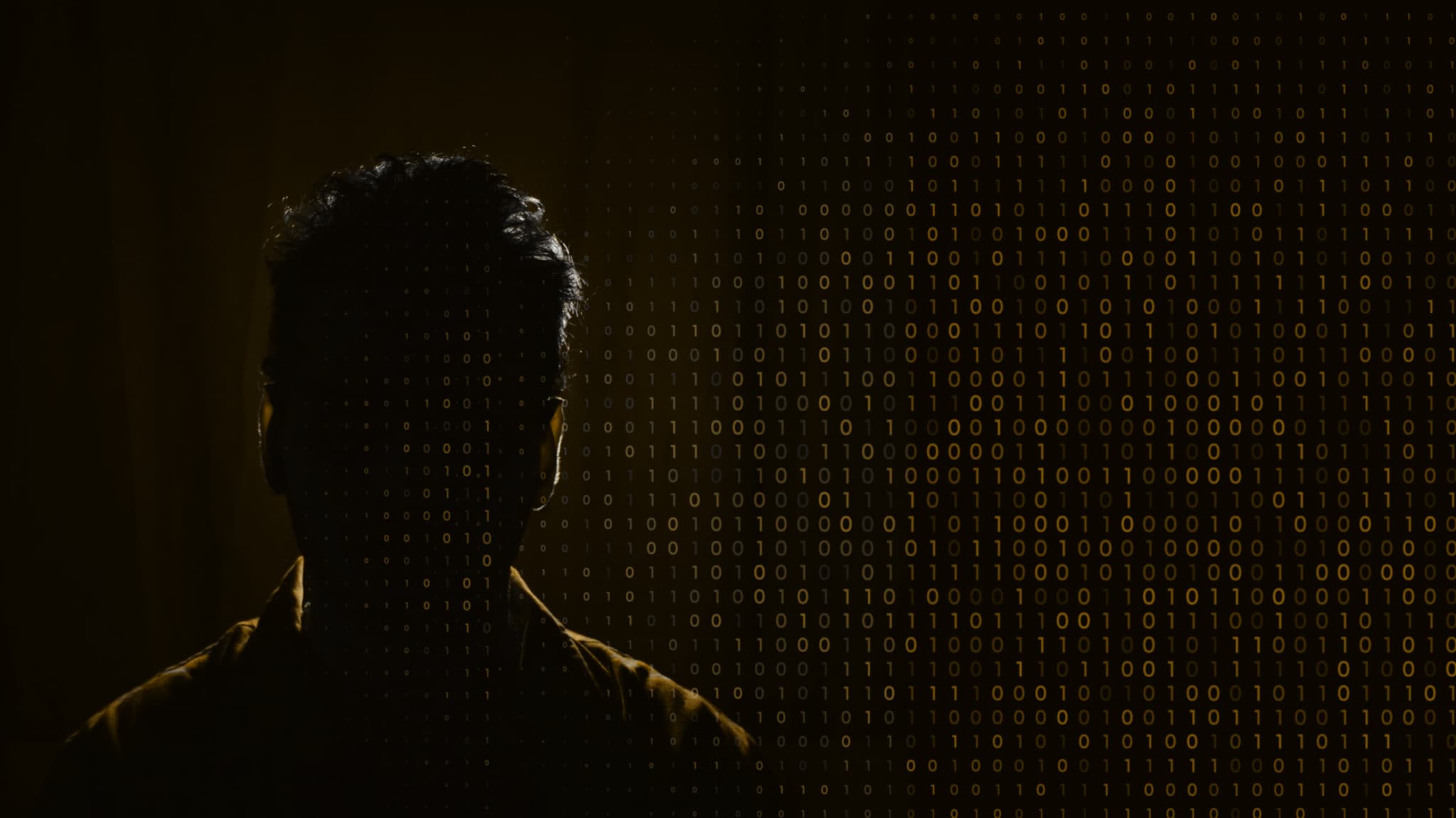 Silhouette of a man overlaid with gold binary code